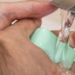 A Trucker washes his hands with soap | trucking safety during a pandemic